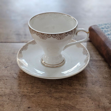 White Porcelain Tea Cup and Saucer with Gold Lace Design